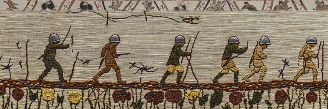 Soldiers in tin helmets advancing past barbed wire above a border of poppies, embroidered in the Bayeux style